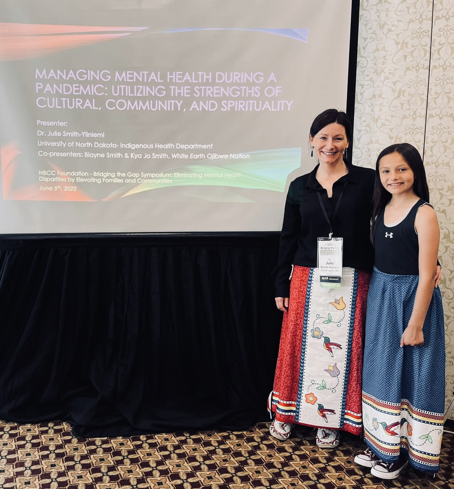 Dr. Julie Smith-Yliniemi and her daughter Kya presenting together at the NBCC Foundation Bridging the Gap Symposium.